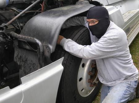 Thief trying to get the computer out of the truck.